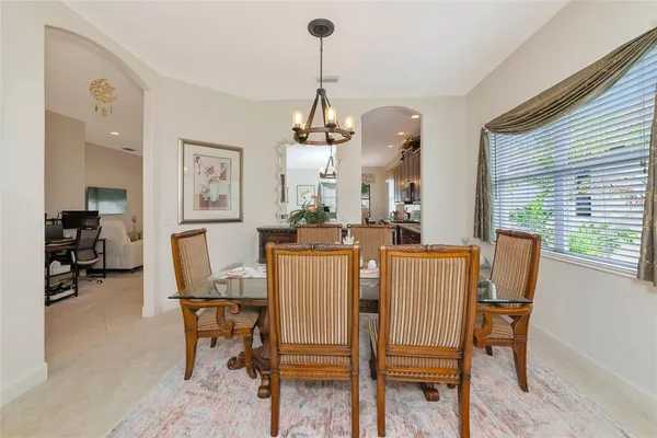 a large kitchen with kitchen island a large counter and chairs