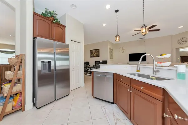 a kitchen with stainless steel appliances granite countertop a refrigerator stove and sink