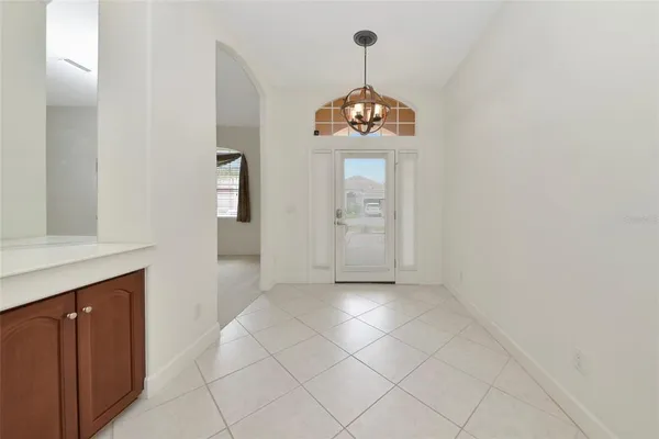 an empty room with wooden floor and hallway