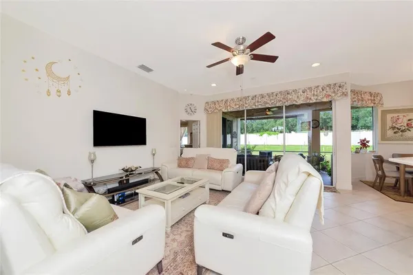 a living room with furniture and kitchen view