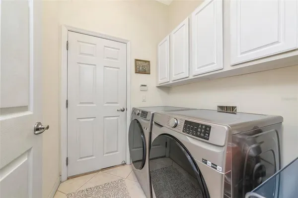 a living room with patio furniture and a large window