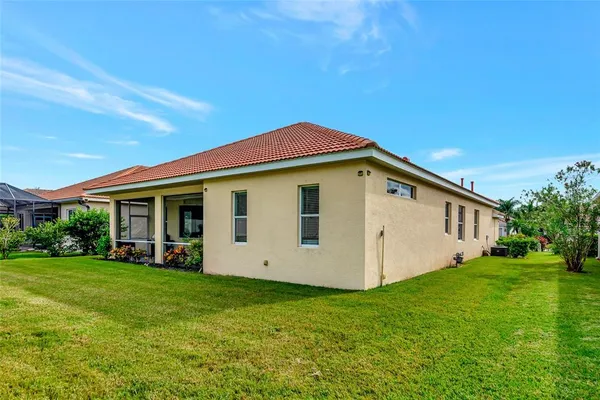 a view of a patio with a table and chairs under an umbrella