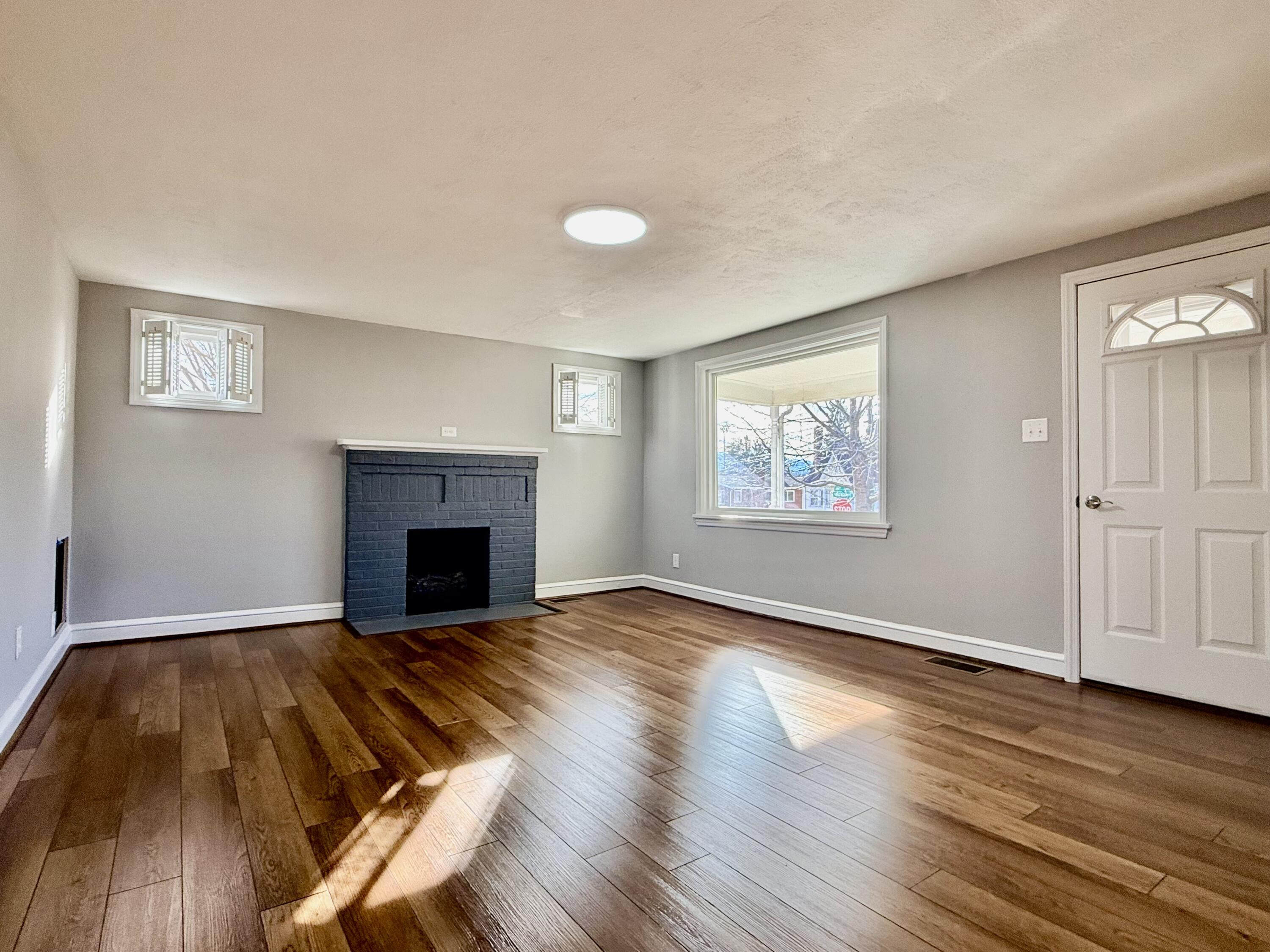 402 Goodwin Avenue Salem, VA 24153 - Photo 2 of 10 a view of an empty room with wooden floor and a window