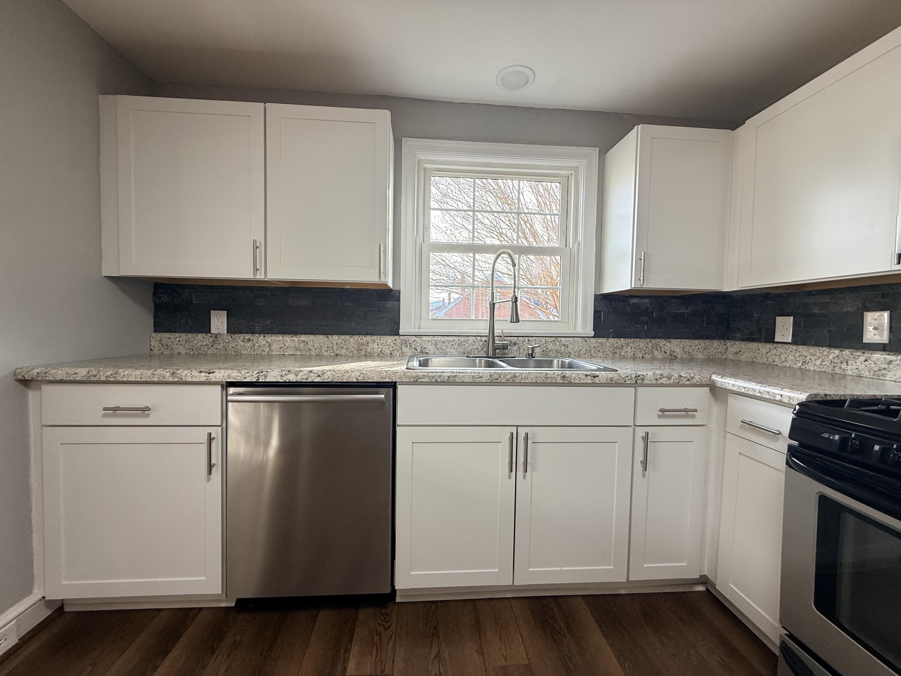 402 Goodwin Avenue Salem, VA 24153 - Photo 3 of 10 a kitchen with granite countertop white cabinets and white appliances