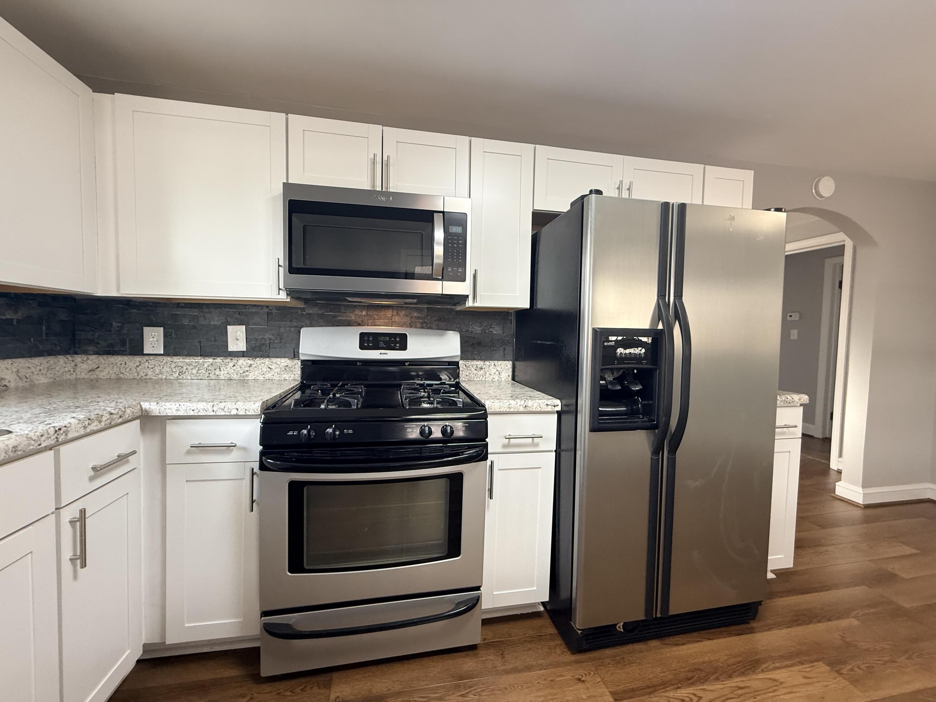 402 Goodwin Avenue Salem, VA 24153 - Photo 4 of 10 a kitchen with stainless steel appliances granite countertop a stove a refrigerator and a microwave