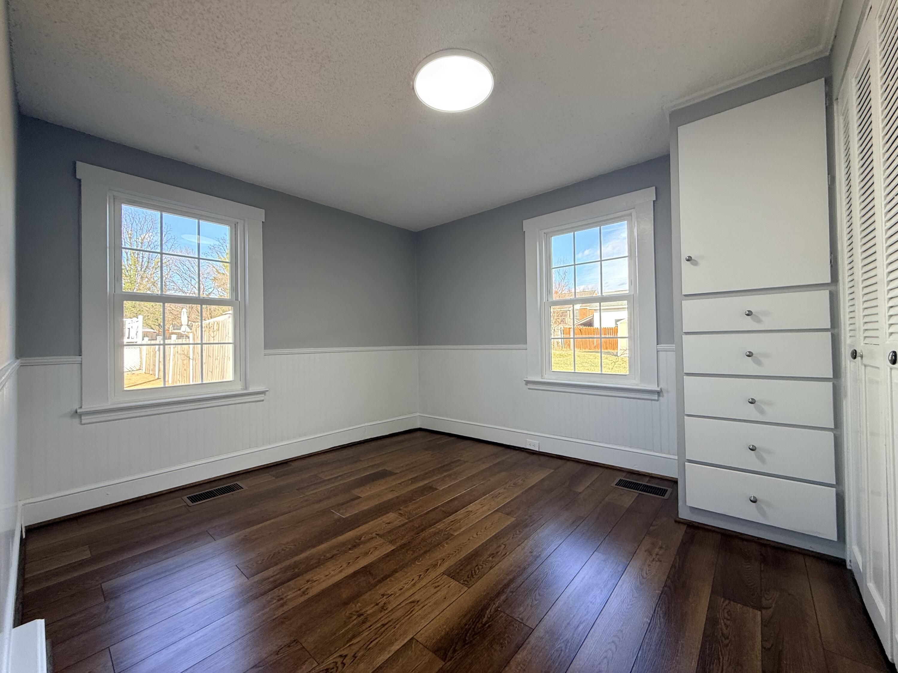 402 Goodwin Avenue Salem, VA 24153 - Photo 7 of 10 an empty room with wooden floor and windows