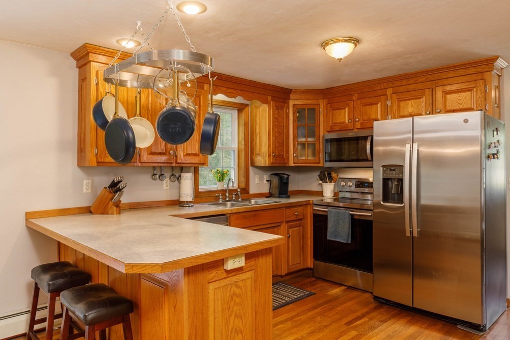 101 Holt Road Ashburnham, MA 01430 - Photo 2 of 22 a kitchen with stainless steel appliances granite countertop a sink a stove and a refrigerator