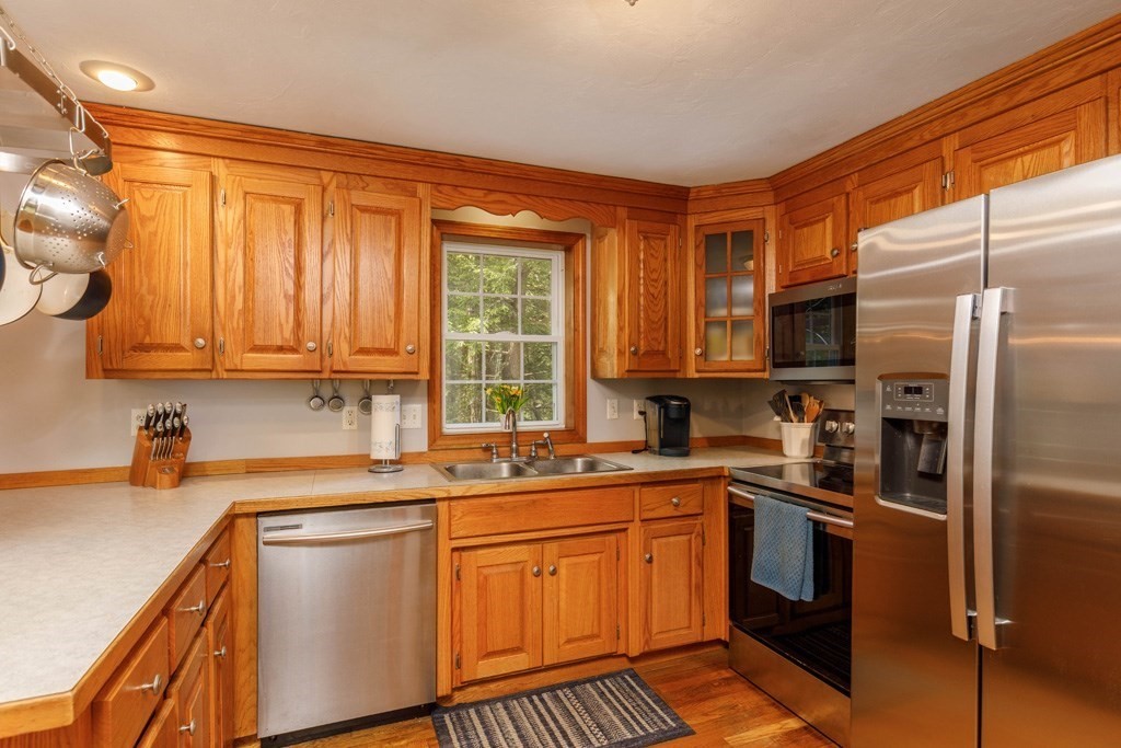 101 Holt Road Ashburnham, MA 01430 - Photo 3 of 22 a kitchen with stainless steel appliances granite countertop a sink stove and refrigerator