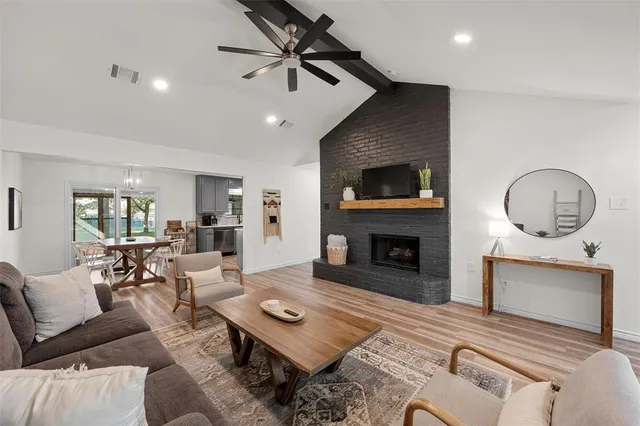 a living room with furniture a fireplace and a flat screen tv