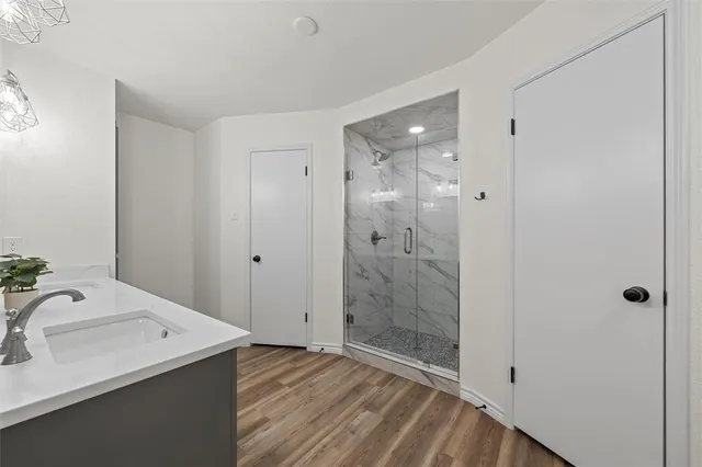 a bathroom with a sink and shower