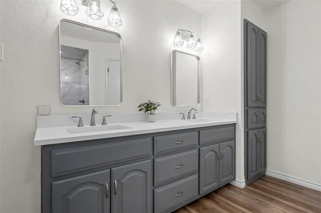 a bathroom with a double vanity sink and a mirror