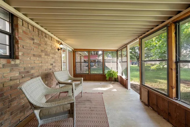 a view of a patio with table and chairs and wooden floor