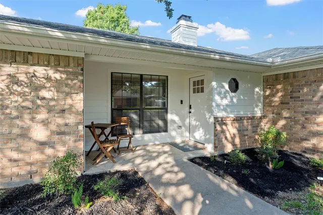 a view of a patio with table and chairs and potted plants