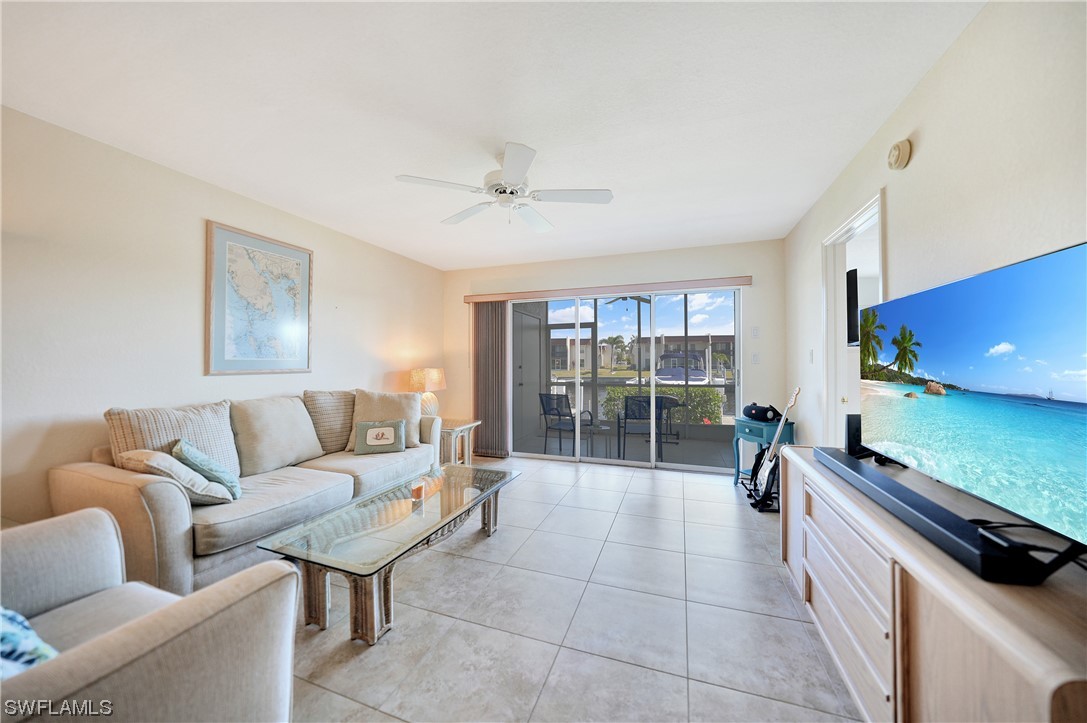 220 Coldeway Drive, Unit 112 Punta Gorda, FL 33950 - Photo 13 of 50 a living room with furniture and a floor to ceiling window