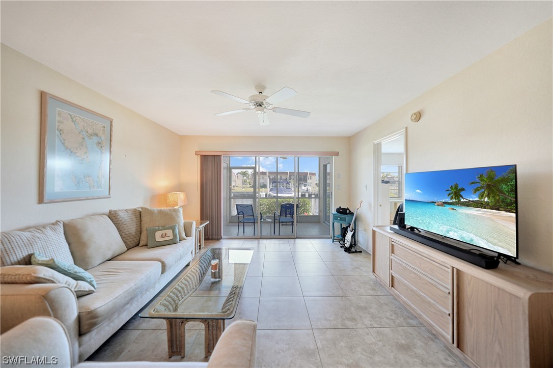 220 Coldeway Drive, Unit 112 Punta Gorda, FL 33950 - Photo 15 of 50 a living room with furniture and a flat screen tv