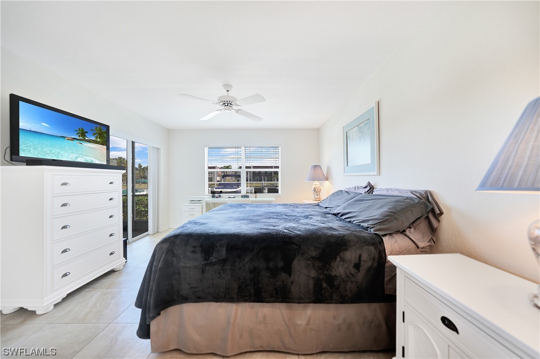 220 Coldeway Drive, Unit 112 Punta Gorda, FL 33950 - Photo 18 of 50 a bedroom with a bed and a flat screen tv
