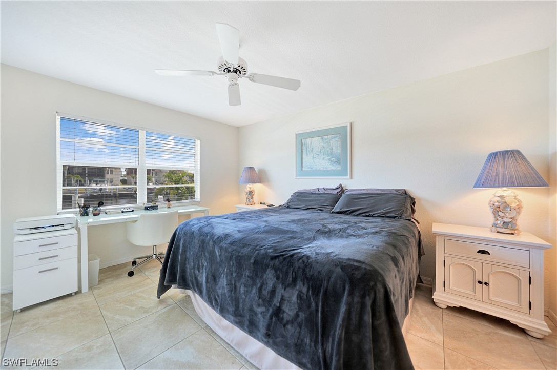 220 Coldeway Drive, Unit 112 Punta Gorda, FL 33950 - Photo 19 of 50 a spacious bedroom with a bed and a window