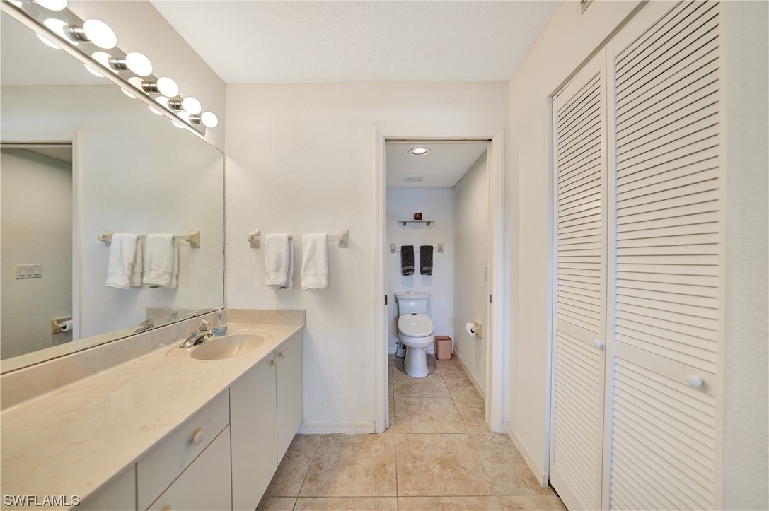 220 Coldeway Drive, Unit 112 Punta Gorda, FL 33950 - Photo 22 of 50 a spacious bathroom with a double vanity sink a mirror and a shower