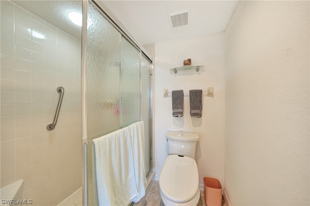 220 Coldeway Drive, Unit 112 Punta Gorda, FL 33950 - Photo 23 of 50 a bathroom with a toilet a sink and shower