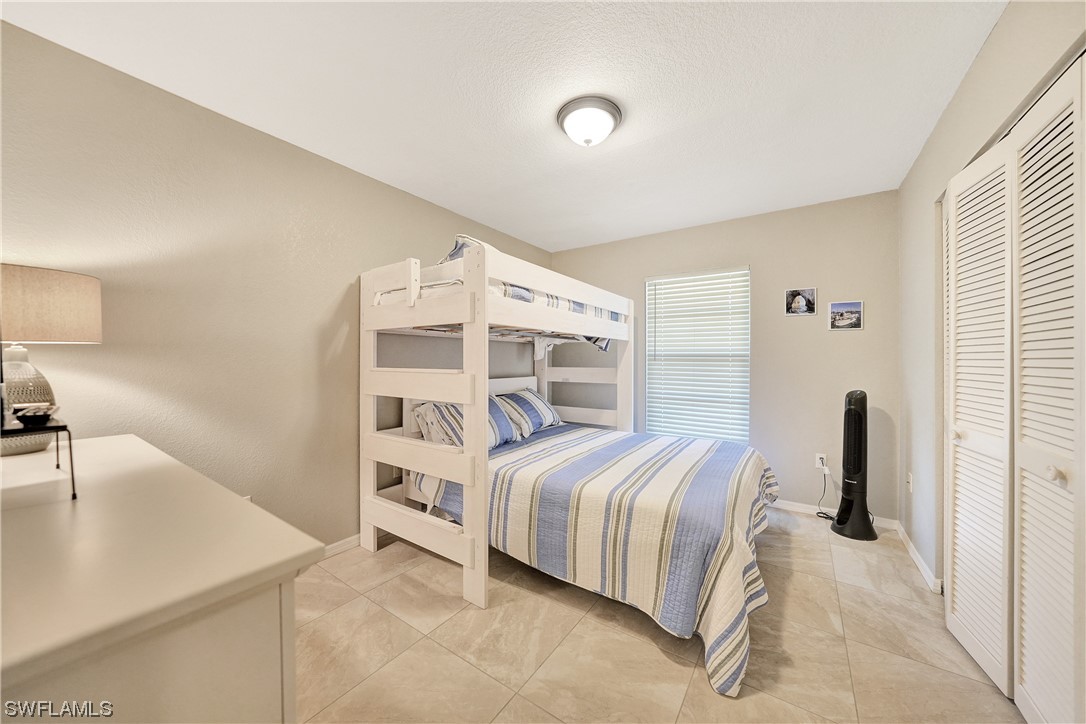 220 Coldeway Drive, Unit 112 Punta Gorda, FL 33950 - Photo 24 of 50 a bedroom with a bed and a sink