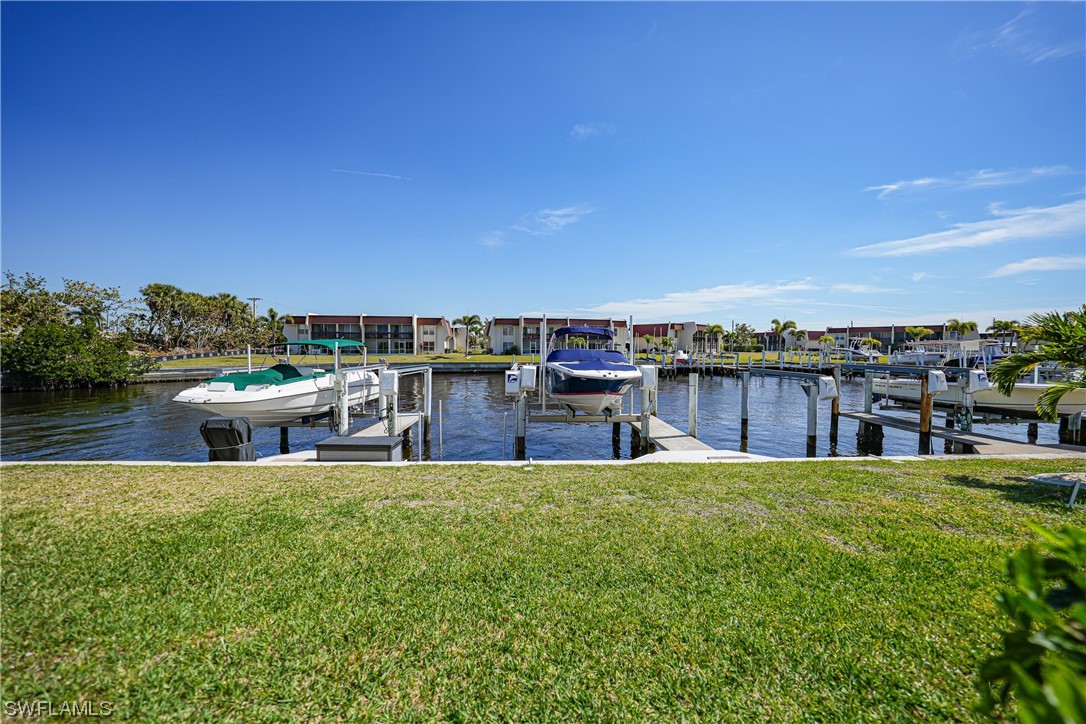220 Coldeway Drive, Unit 112 Punta Gorda, FL 33950 - Photo 32 of 50 a view of a swimming pool with lawn chairs