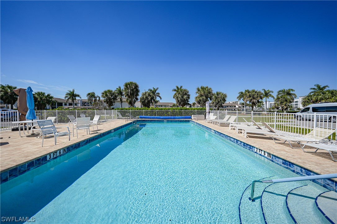 220 Coldeway Drive, Unit 112 Punta Gorda, FL 33950 - Photo 35 of 50 a view of a swimming pool with an outdoor seating and a mountain view
