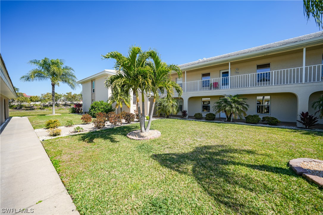 220 Coldeway Drive, Unit 112 Punta Gorda, FL 33950 - Photo 40 of 50 a front view of house with yard and swimming pool