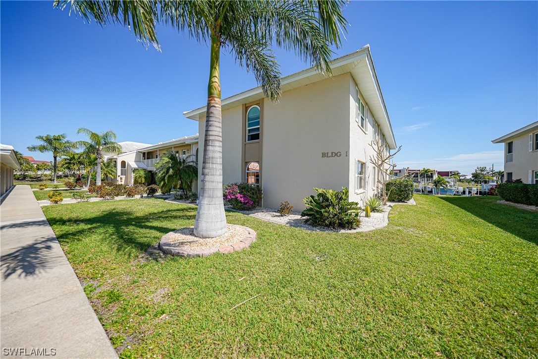 220 Coldeway Drive, Unit 112 Punta Gorda, FL 33950 - Photo 41 of 50 a front view of a house with garden