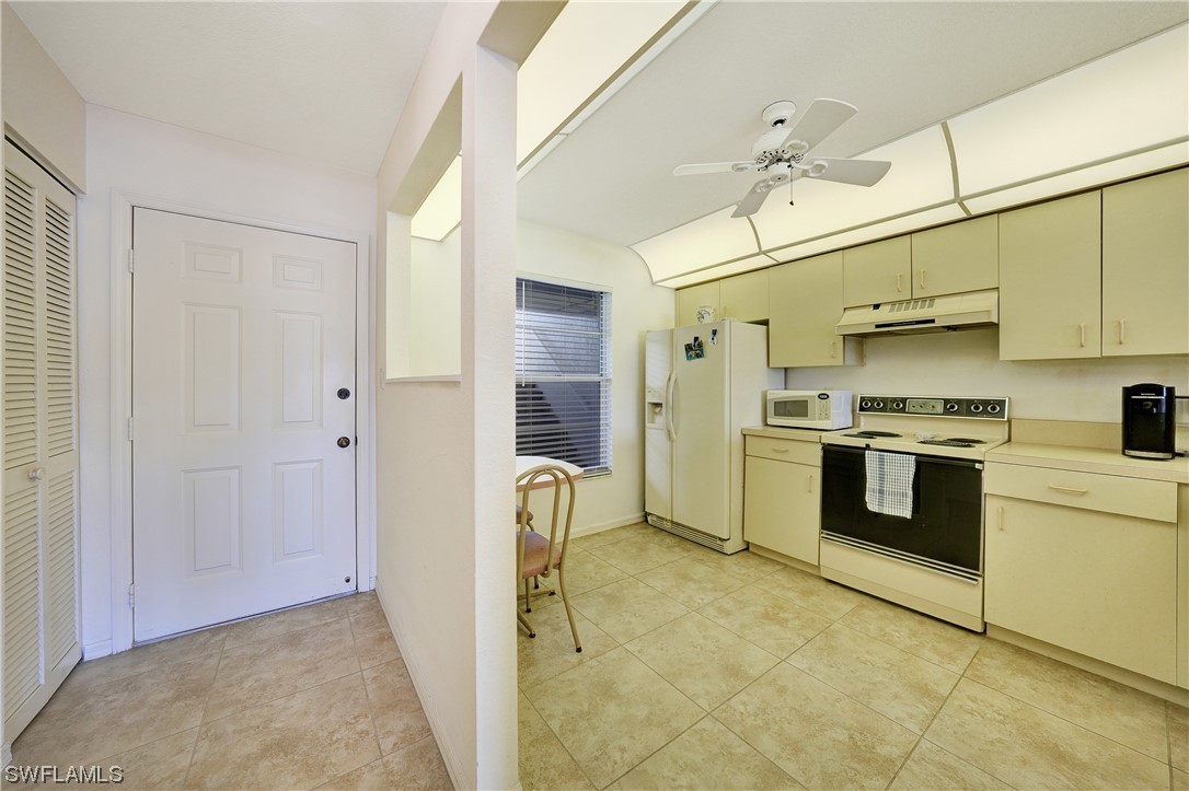 220 Coldeway Drive, Unit 112 Punta Gorda, FL 33950 - Photo 6 of 50 a kitchen with stainless steel appliances granite countertop a stove a sink and a refrigerator
