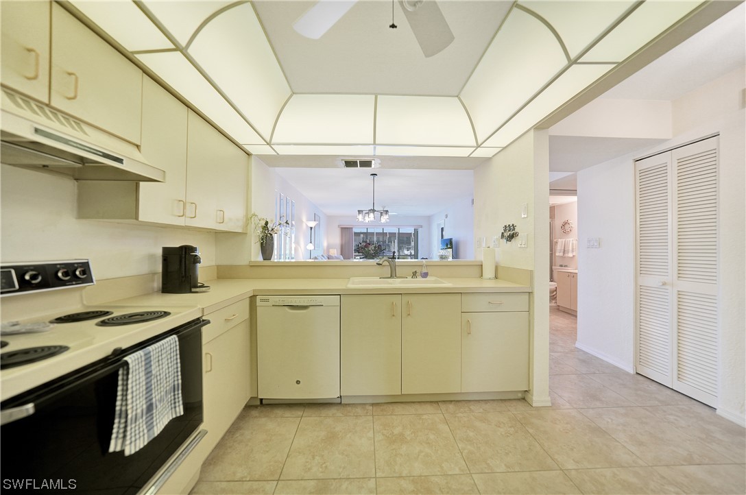 220 Coldeway Drive, Unit 112 Punta Gorda, FL 33950 - Photo 9 of 50 a kitchen with a stove cabinets and a refrigerator
