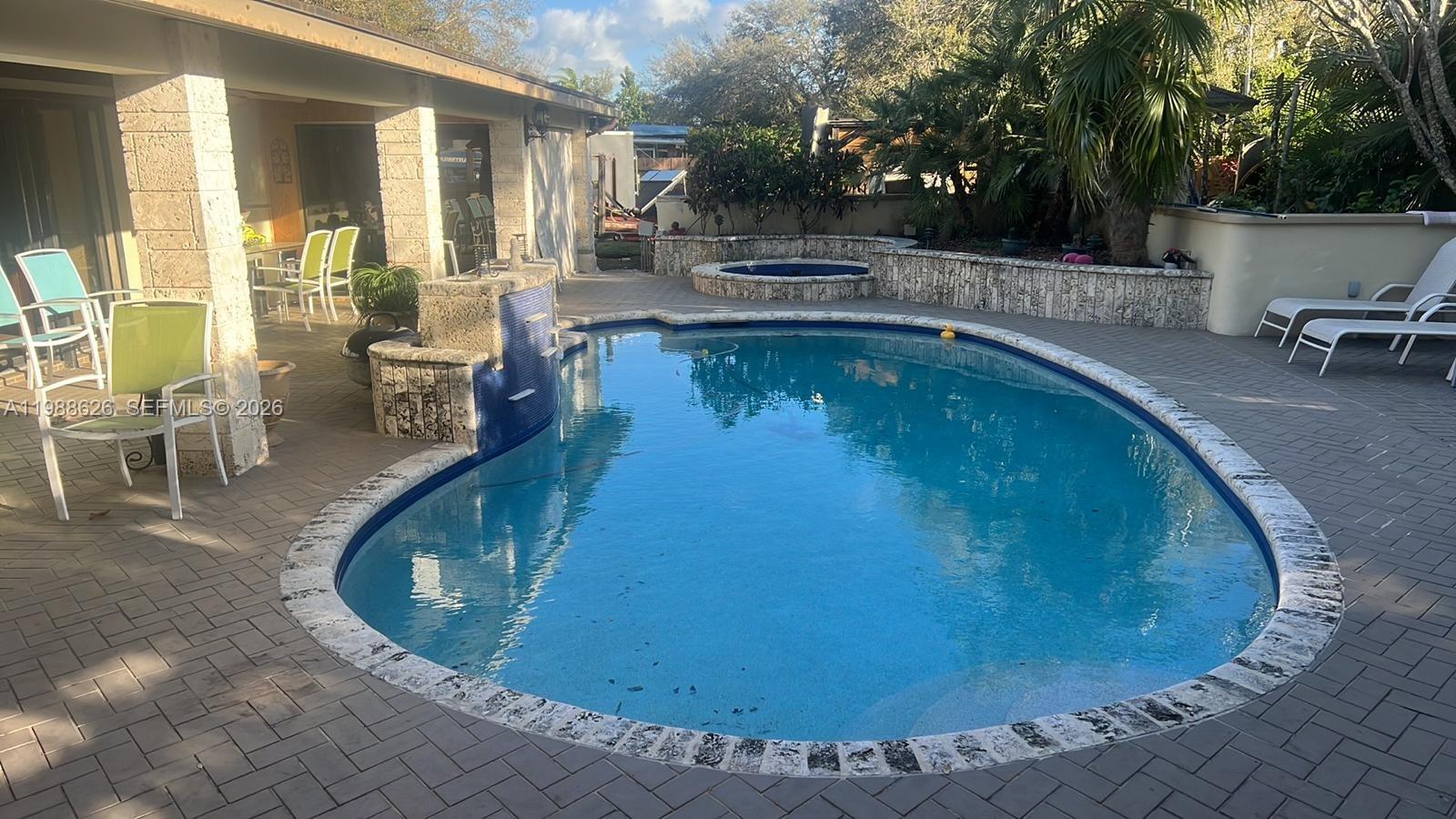 30705 Southwest 197th Avenue Homestead, FL 33030 - Photo 15 of 17 a view of a swimming pool with chairs