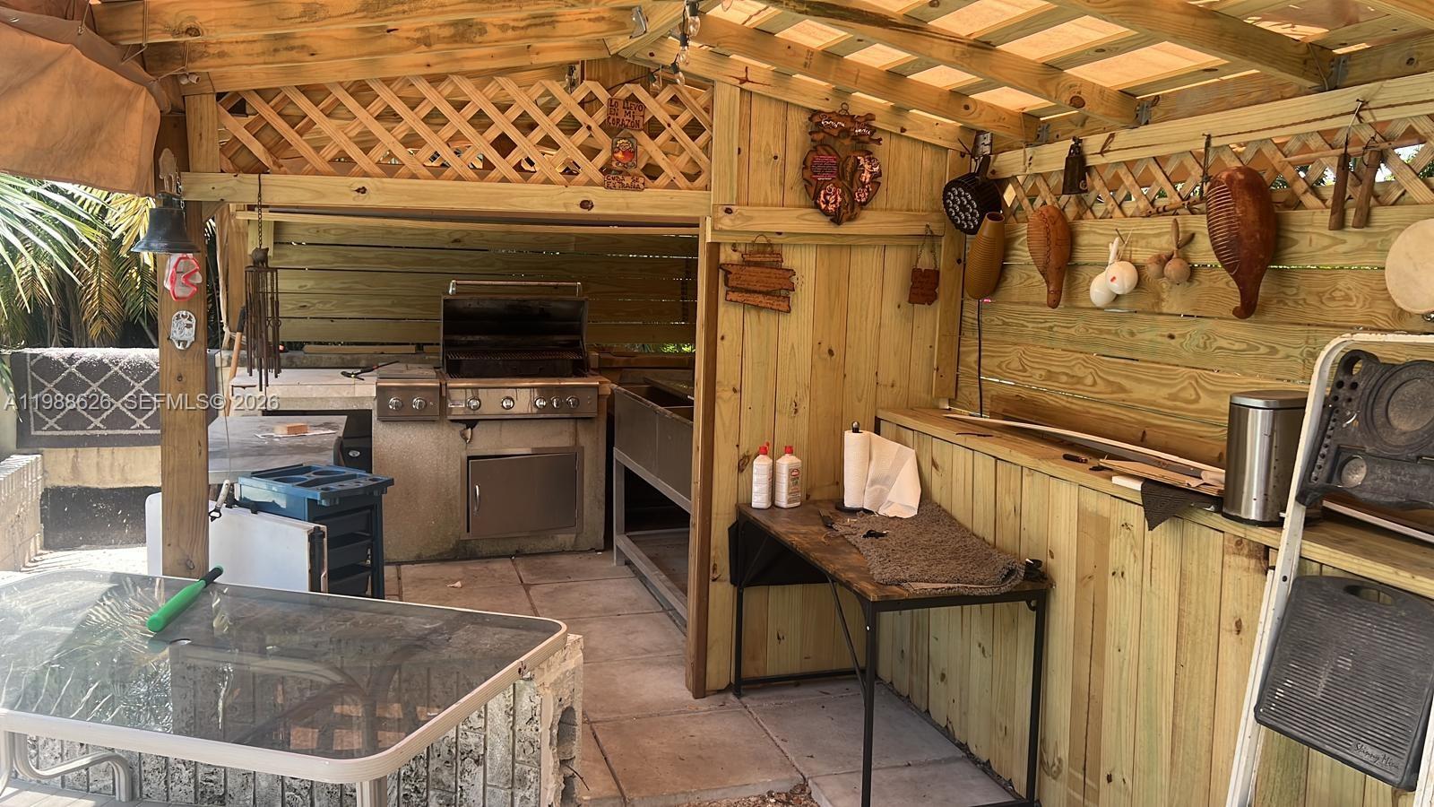 30705 Southwest 197th Avenue Homestead, FL 33030 - Photo 16 of 17 a kitchen with a stove a sink and a refrigerator