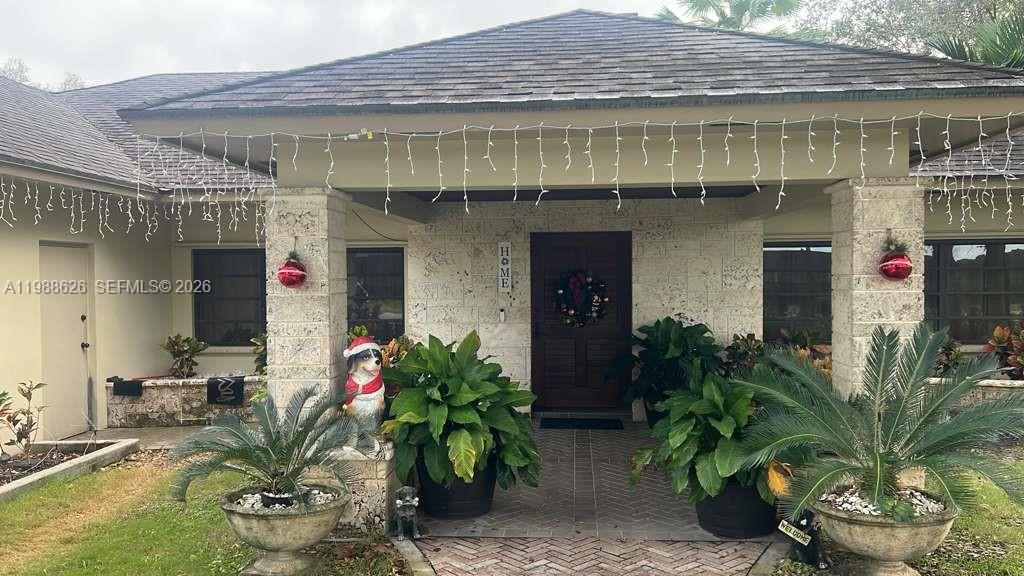 30705 Southwest 197th Avenue Homestead, FL 33030 - Photo 2 of 17 a front view of a house with a yard