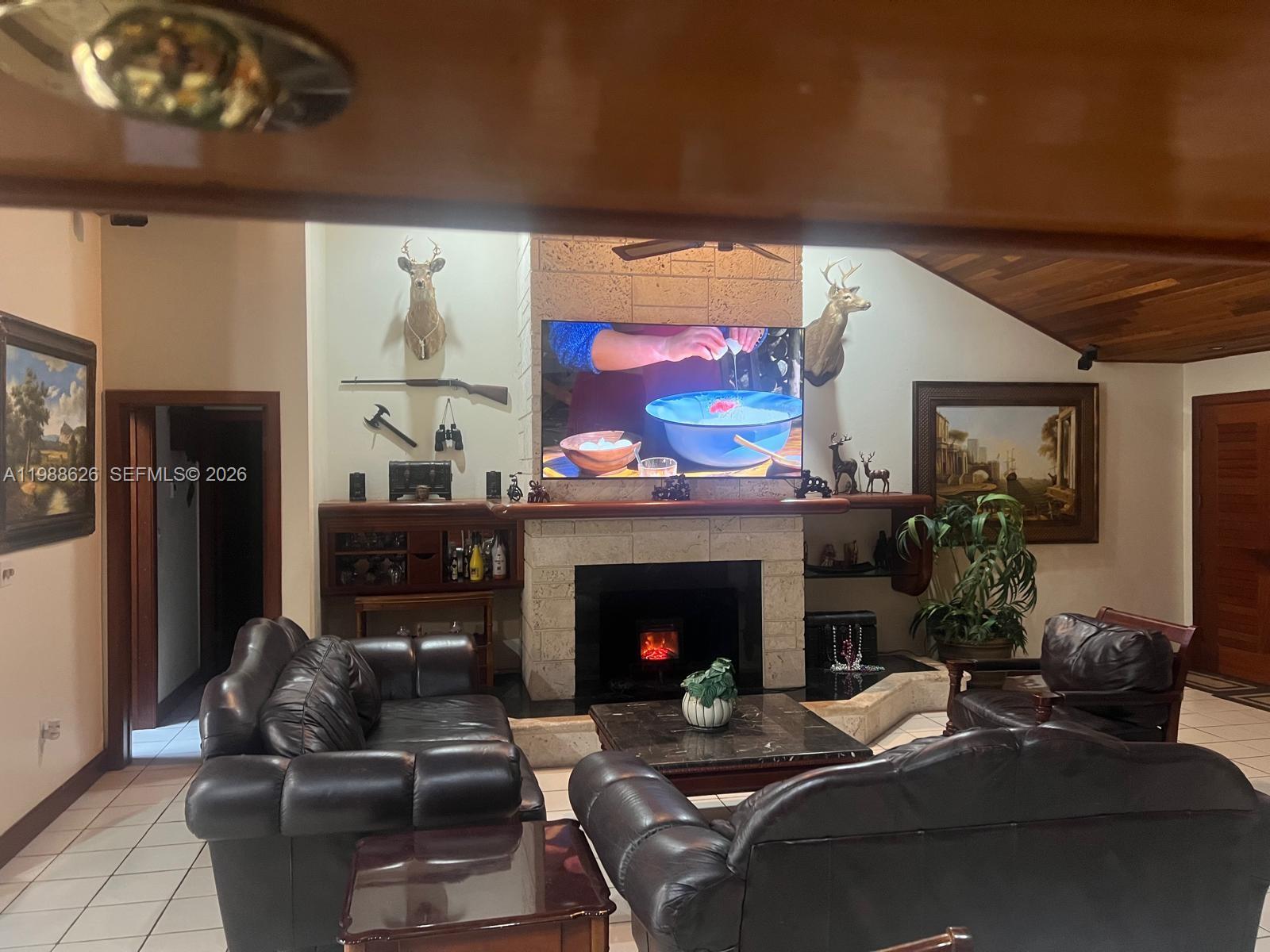 30705 Southwest 197th Avenue Homestead, FL 33030 - Photo 6 of 17 a living room with furniture and a fireplace