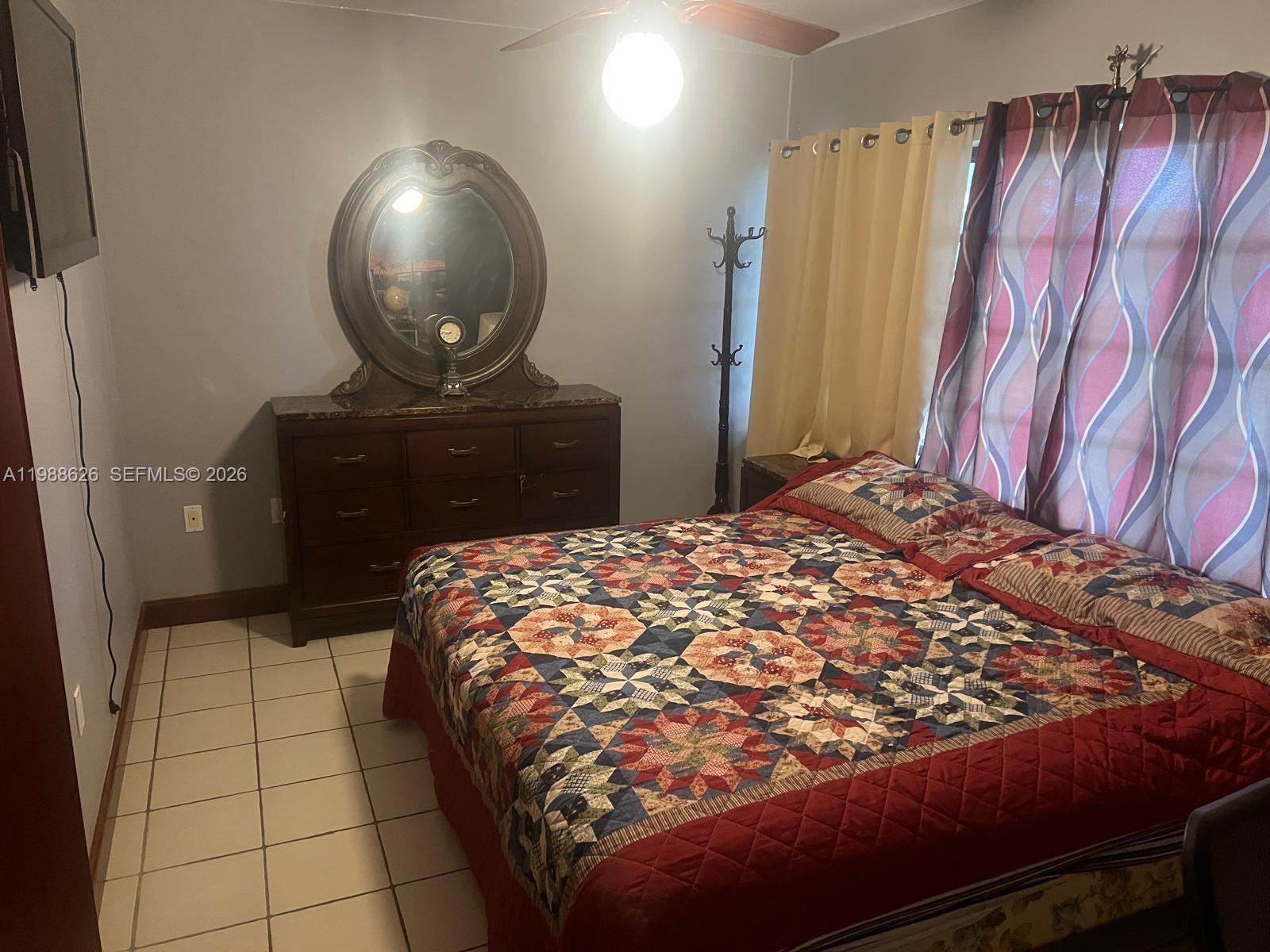 30705 Southwest 197th Avenue Homestead, FL 33030 - Photo 7 of 17 a bedroom with a bed and a dresser