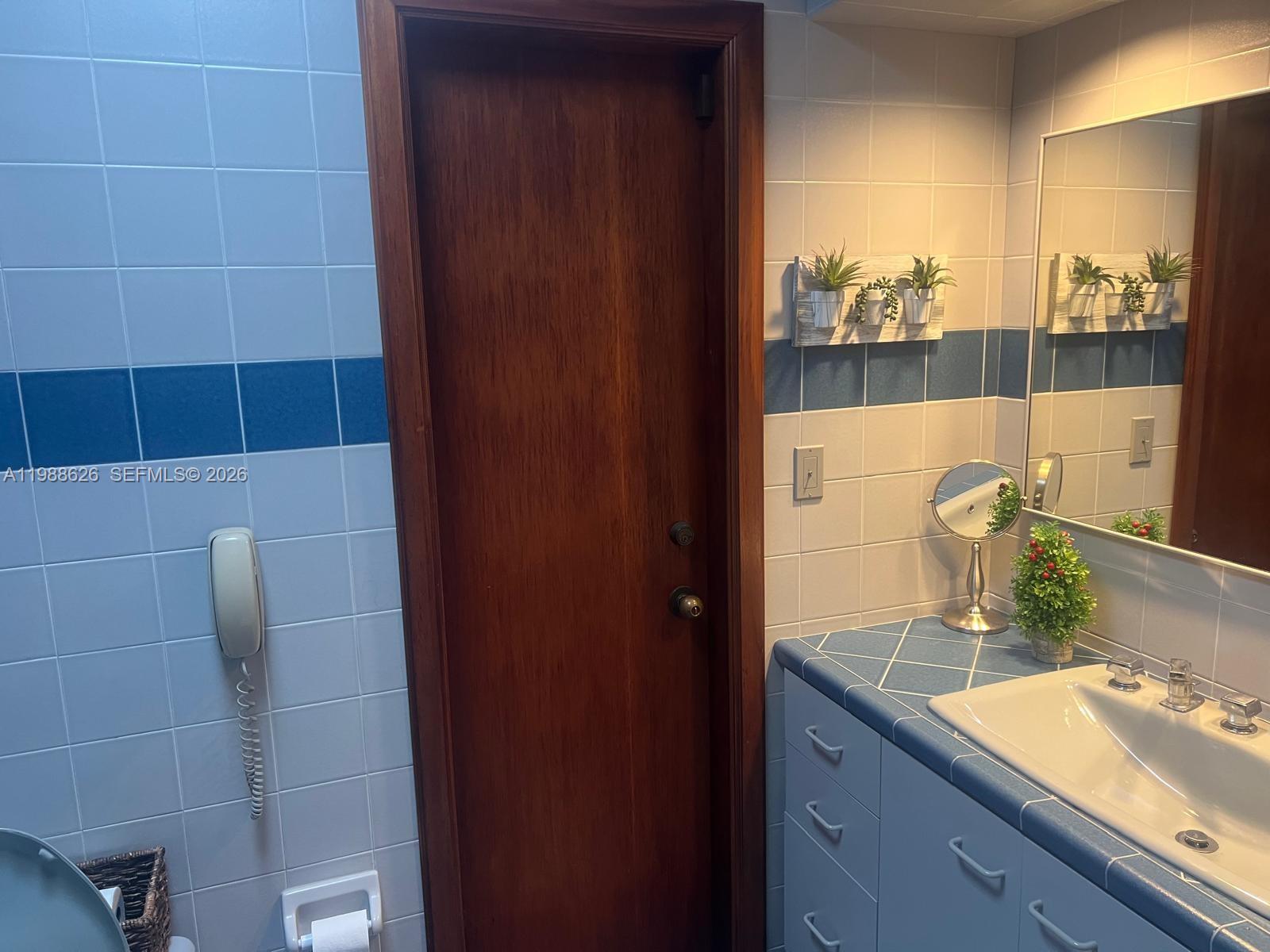 30705 Southwest 197th Avenue Homestead, FL 33030 - Photo 8 of 17 a bathroom with a granite countertop sink and a mirror
