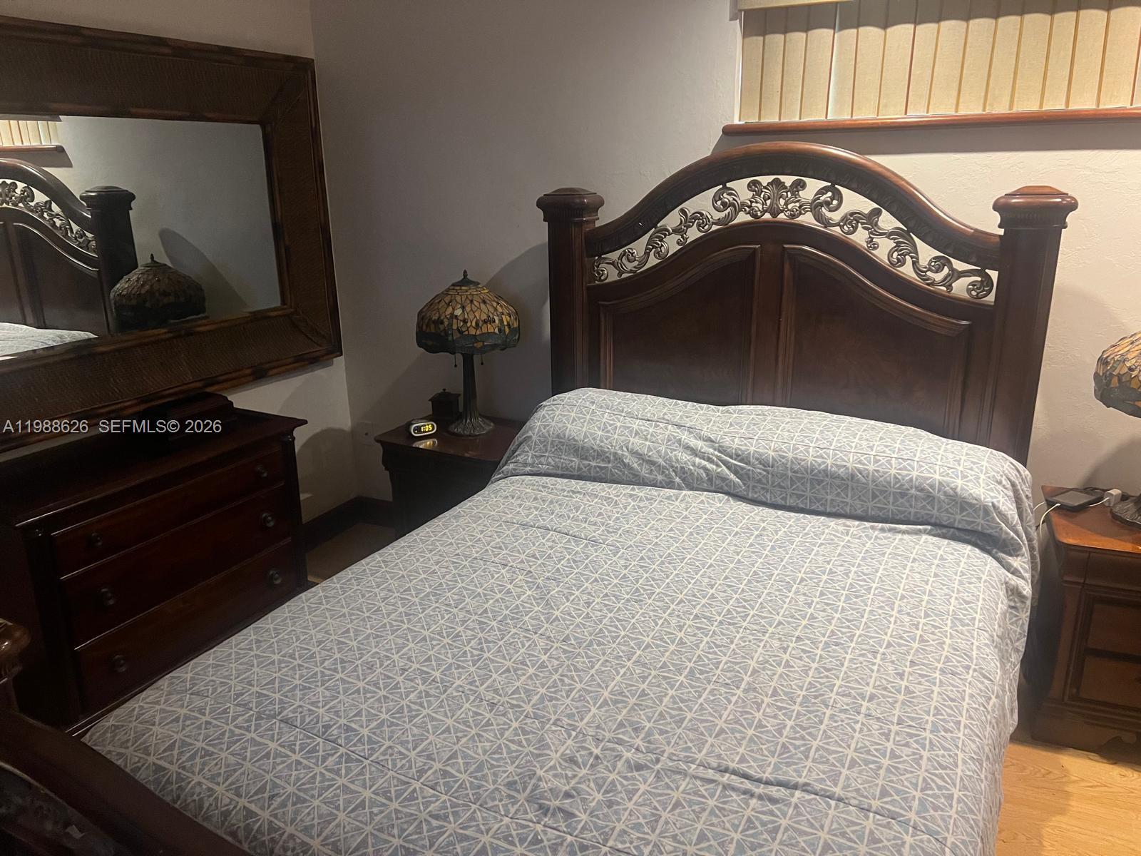 30705 Southwest 197th Avenue Homestead, FL 33030 - Photo 9 of 17 a bedroom with a bed and a dresser