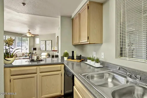 a kitchen with granite countertop a sink and cabinets