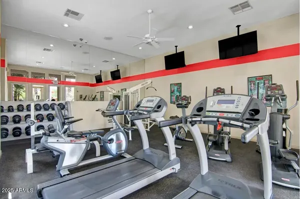 a room with gym equipment and a large window