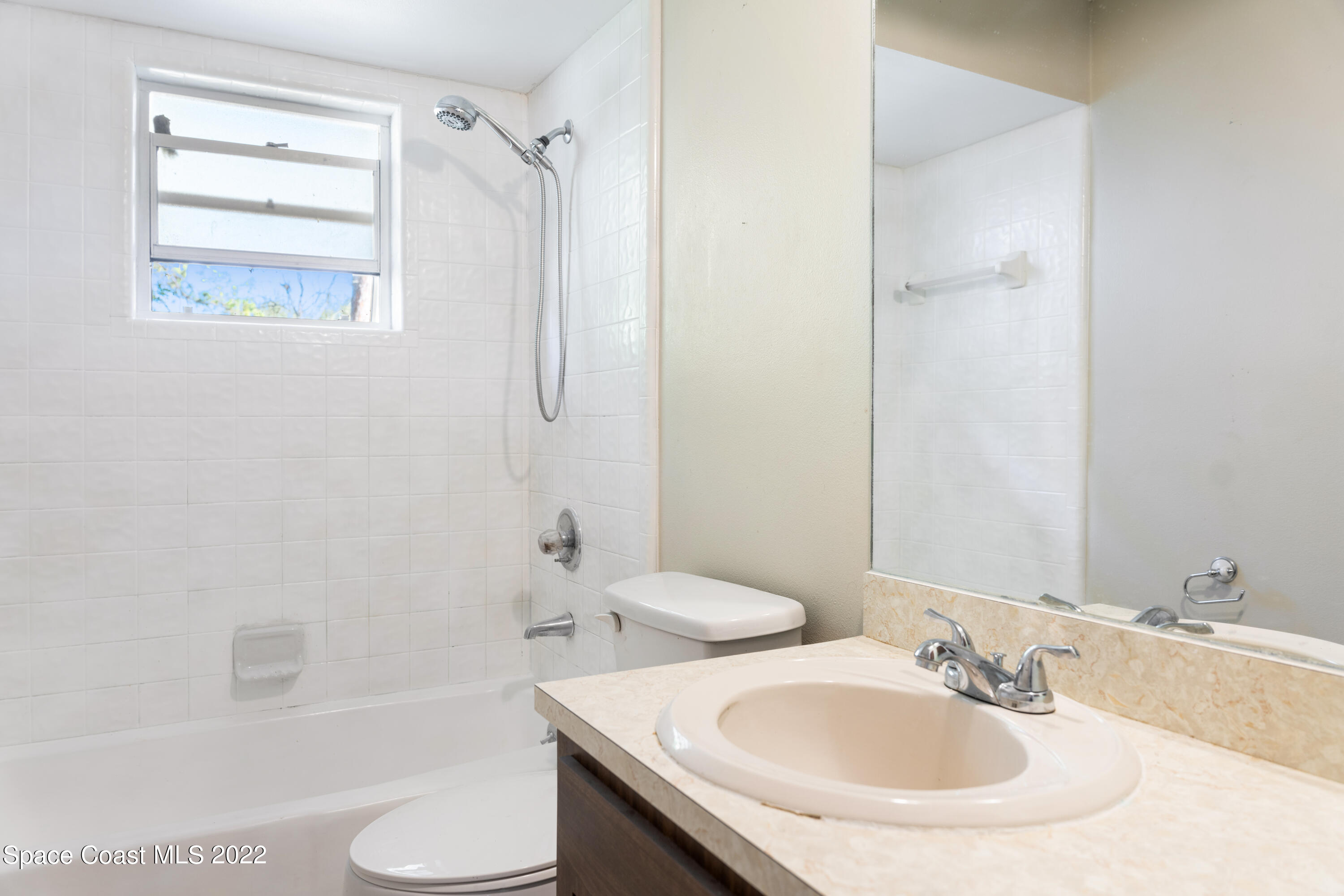415 Cortez Road Palm Bay, FL 32907 - Photo 16 of 22 a bathroom with a sink toilet and shower