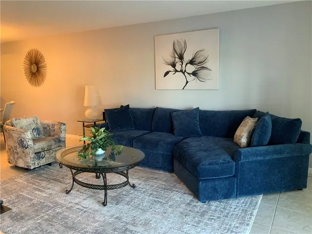 a bedroom with a bed and a lamp