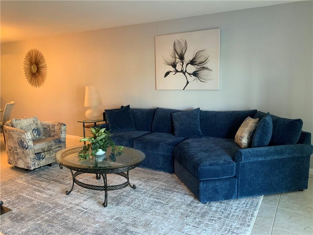 5530 Rattlesnake Hammock Road, Unit K103 Naples, FL 34112 - Photo 13 of 32 a living room with furniture and a potted plant