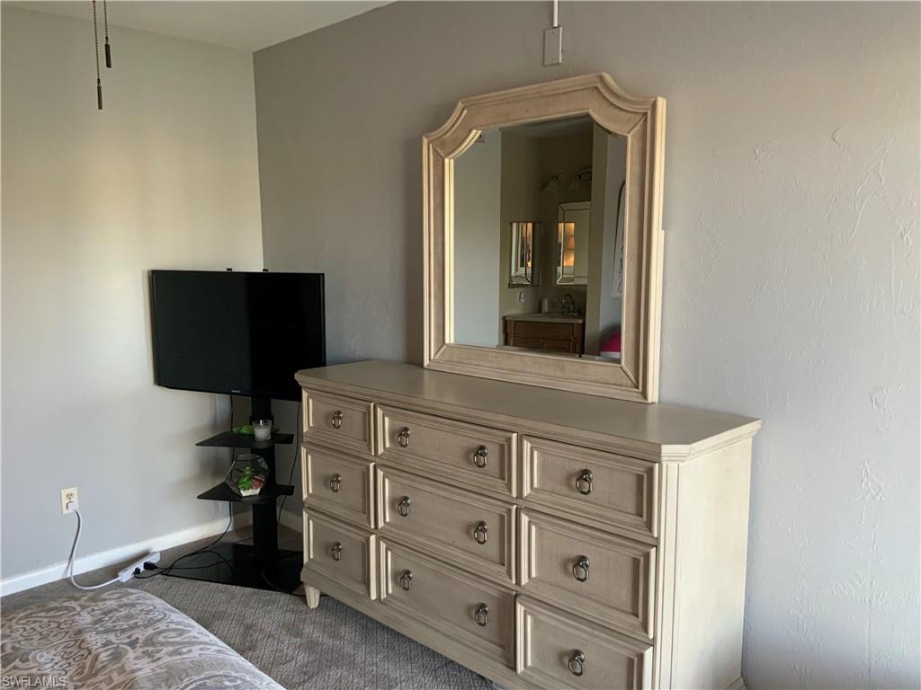 5530 Rattlesnake Hammock Road, Unit K103 Naples, FL 34112 - Photo 16 of 32 a view of walk in closet with clothes and shoes