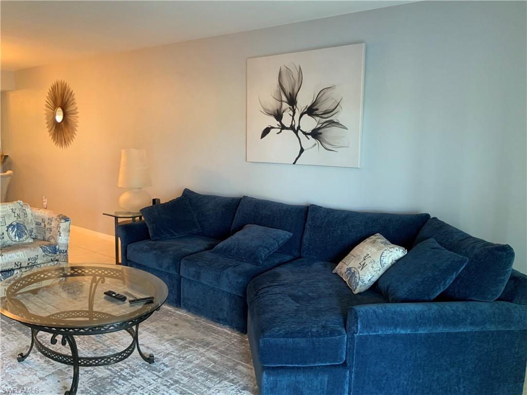 5530 Rattlesnake Hammock Road, Unit K103 Naples, FL 34112 - Photo 17 of 32 a living room with furniture and a rug