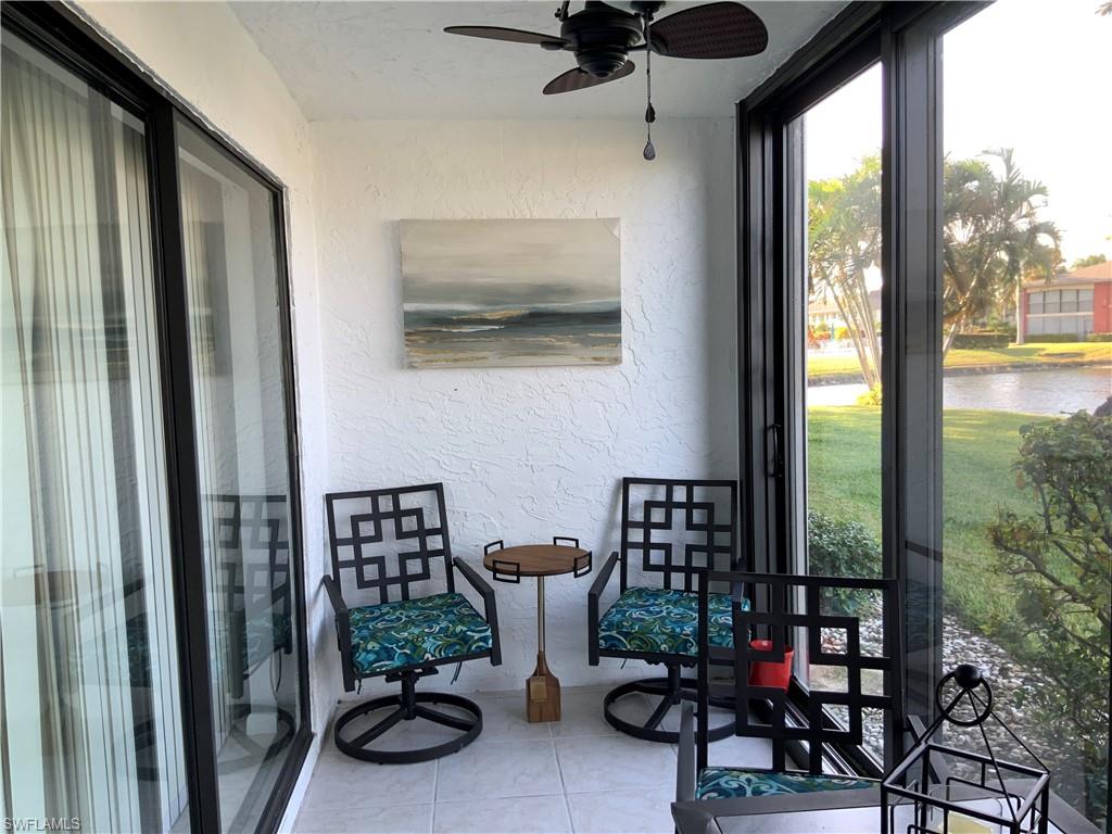 5530 Rattlesnake Hammock Road, Unit K103 Naples, FL 34112 - Photo 18 of 32 a view of a chairs and table in a balcony