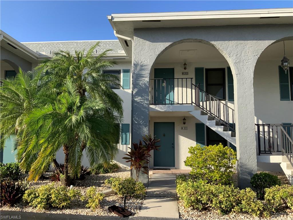 5530 Rattlesnake Hammock Road, Unit K103 Naples, FL 34112 - Photo 20 of 32 a front view of a house with a yard