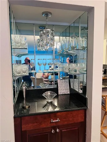 a kitchen with granite countertop white cabinets and stainless steel appliances