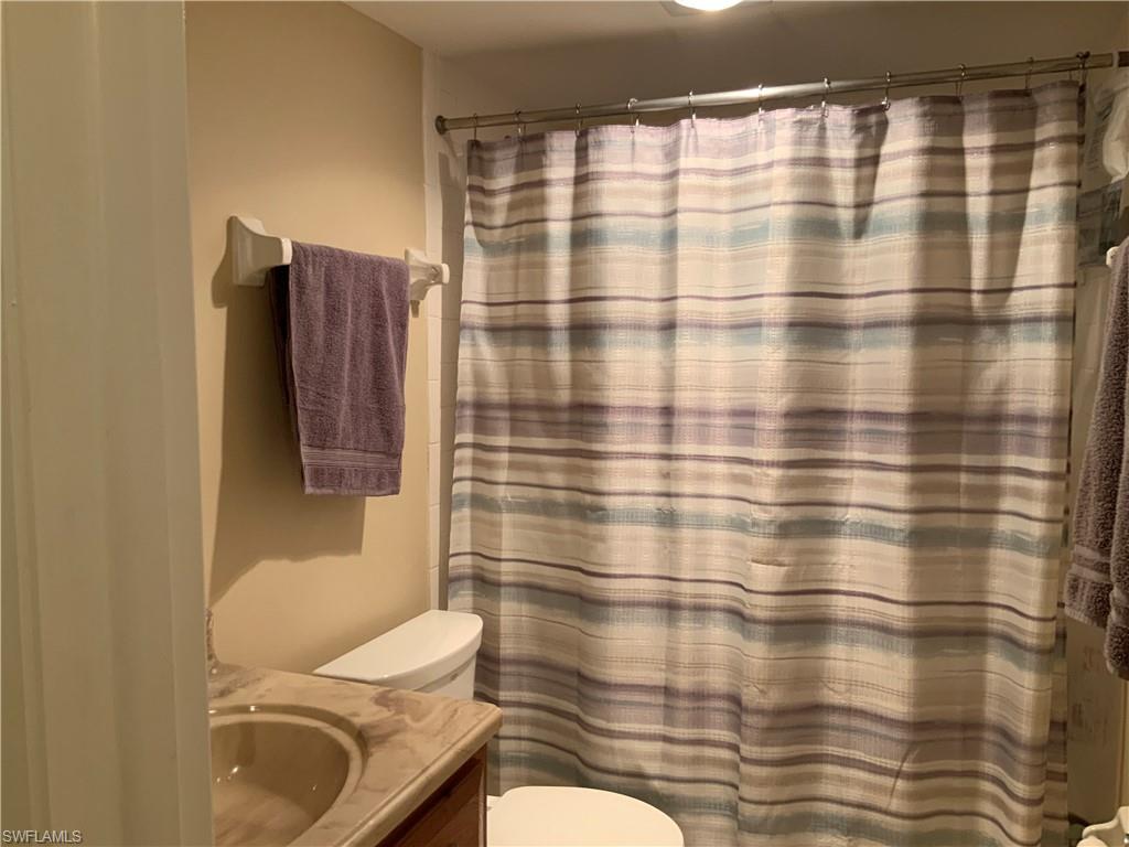 5530 Rattlesnake Hammock Road, Unit K103 Naples, FL 34112 - Photo 24 of 32 a bathroom with a sink toilet and shower