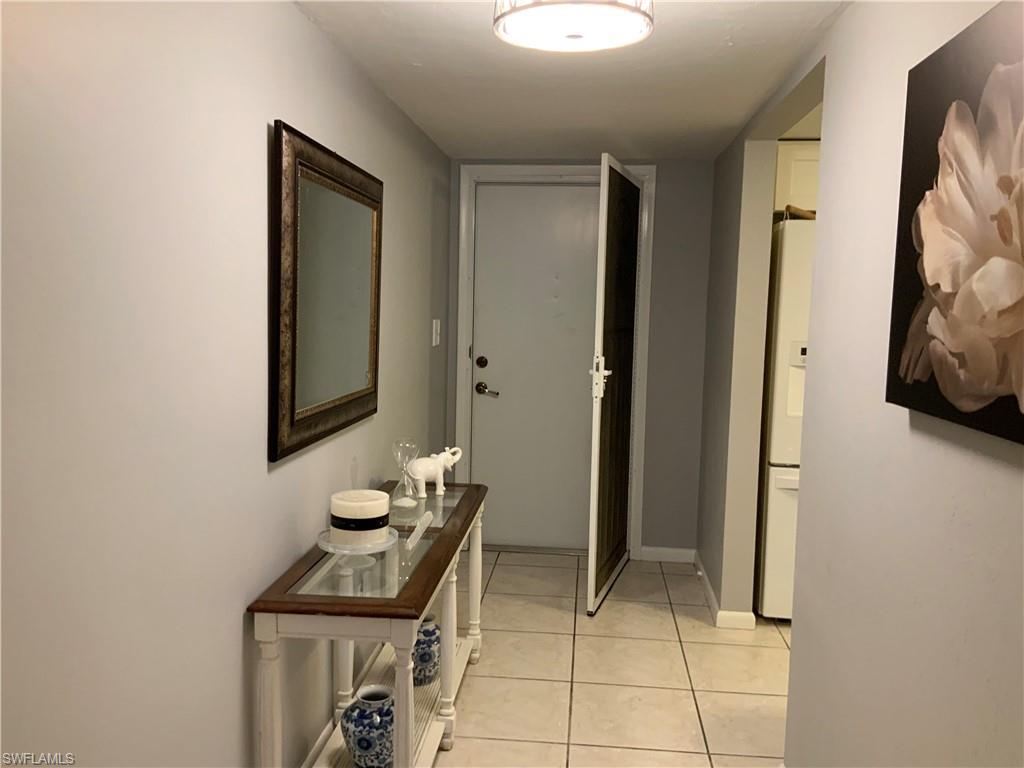 5530 Rattlesnake Hammock Road, Unit K103 Naples, FL 34112 - Photo 26 of 32 a bathroom with a sink and a mirror