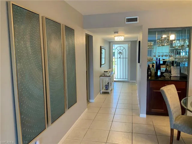a living room with furniture a rug and a flat screen tv